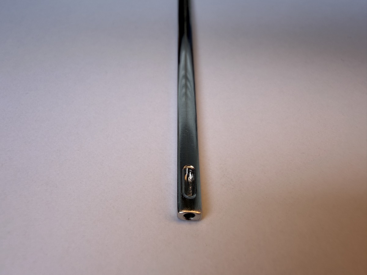 Close-up of the tip of a hand-finished Flosser Wand, showing the brushed finish
